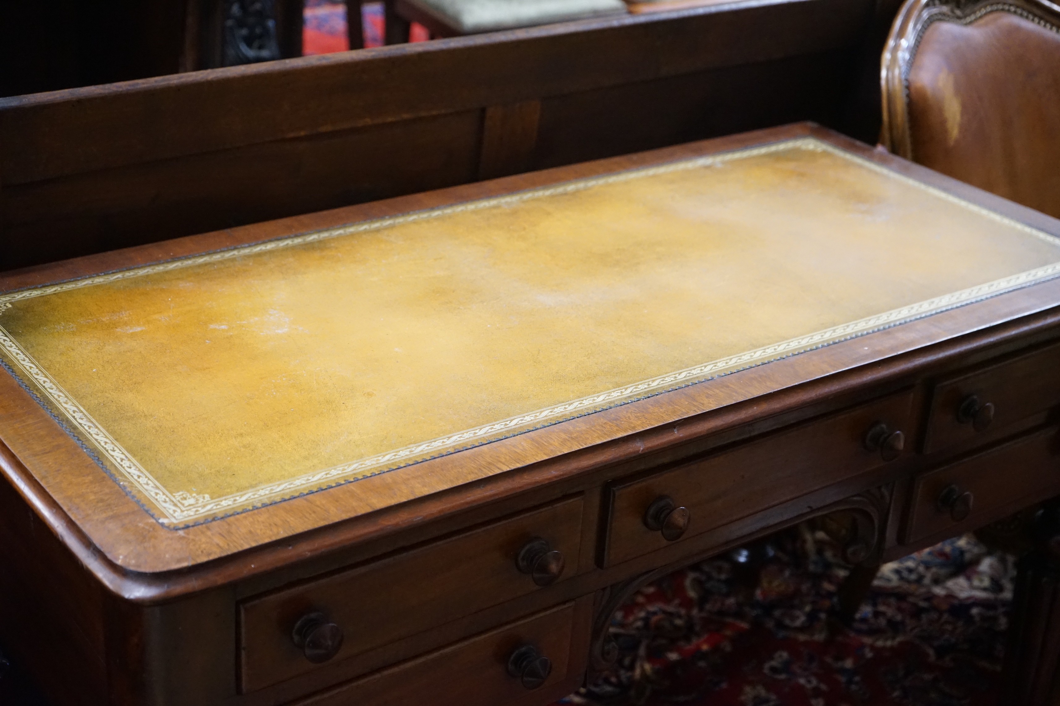 A Victorian mahogany kneehole writing table, width 119cm, depth 55cm, height 74cm